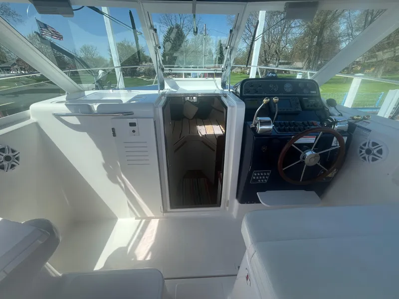 Slide: The Image of 2007 Tiara Yachts 2900 Coronet interior with helm, seating, and cabin entrance. - 24