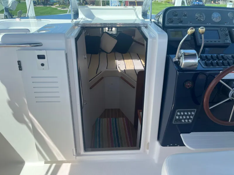 Slide: The Image of 2007 Tiara Yachts 2900 Coronet cabin entrance with helm and seating area. - 25