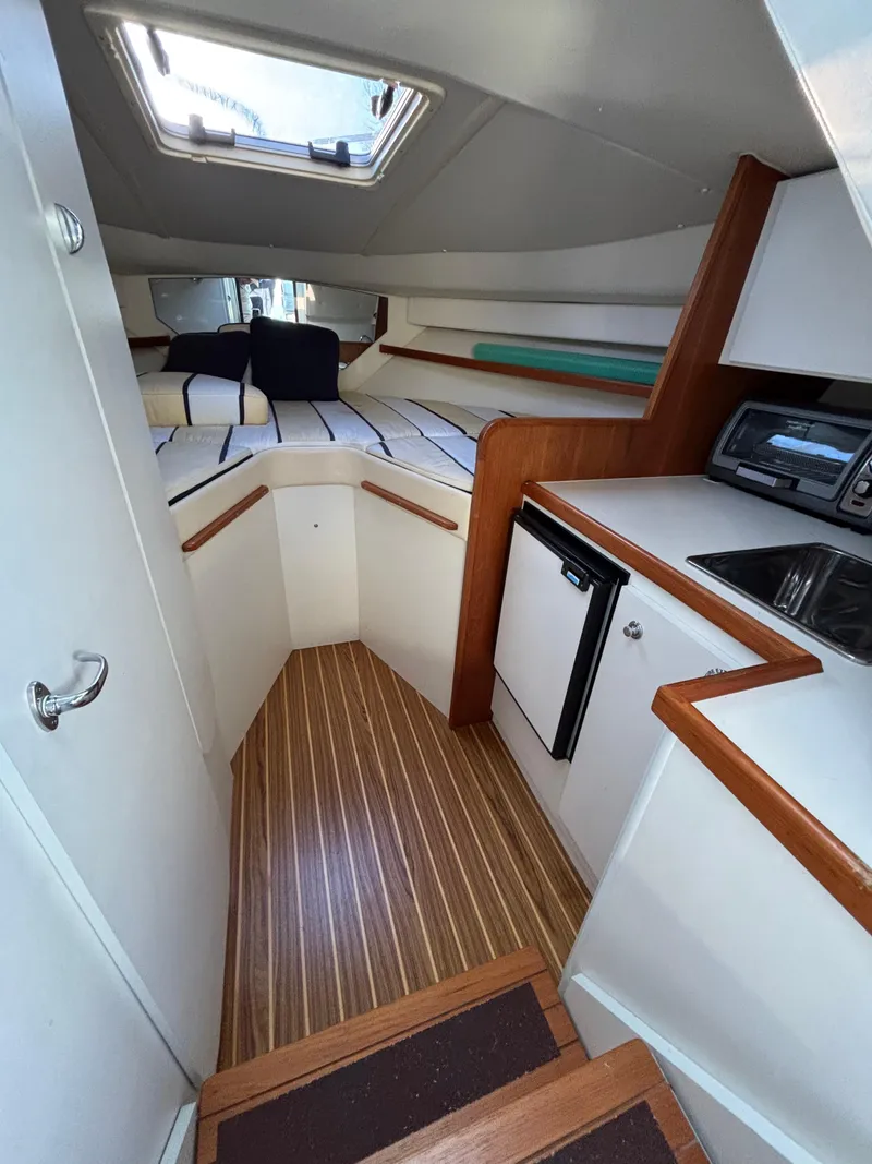 Slide: The Image of 2007 Tiara Yachts 2900 Coronet cabin interior with kitchenette and bed. - 26