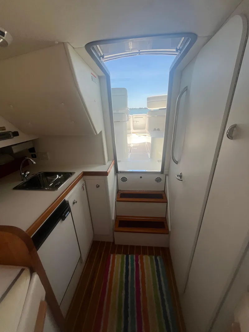 Slide: The Image of Interior of 2007 Tiara Yachts 2900 Coronet with kitchenette and colorful rug. - 29