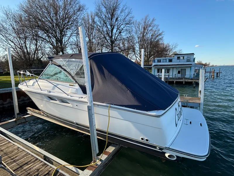 Slide: The Image of 2007 Tiara Yachts 2900 Coronet docked by a lakeside house. - 3