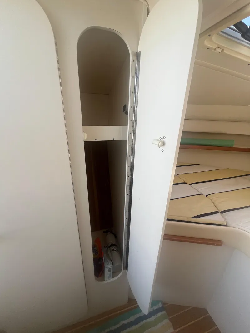 Slide: The Image of 2007 Tiara Yachts 2900 Coronet interior storage compartment with open door. - 31