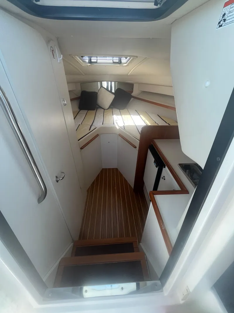 Slide: The Image of 2007 Tiara Yachts 2900 Coronet cabin interior with wood flooring and cozy seating. - 32