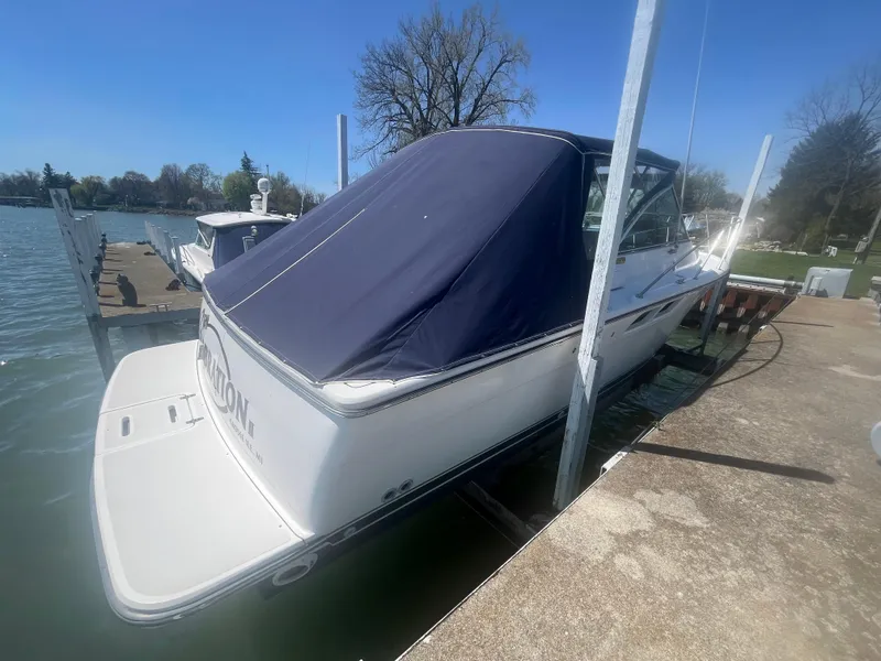 Slide: The Image of 2007 Tiara Yachts 2900 Coronet docked with blue cover, sunny day. - 4