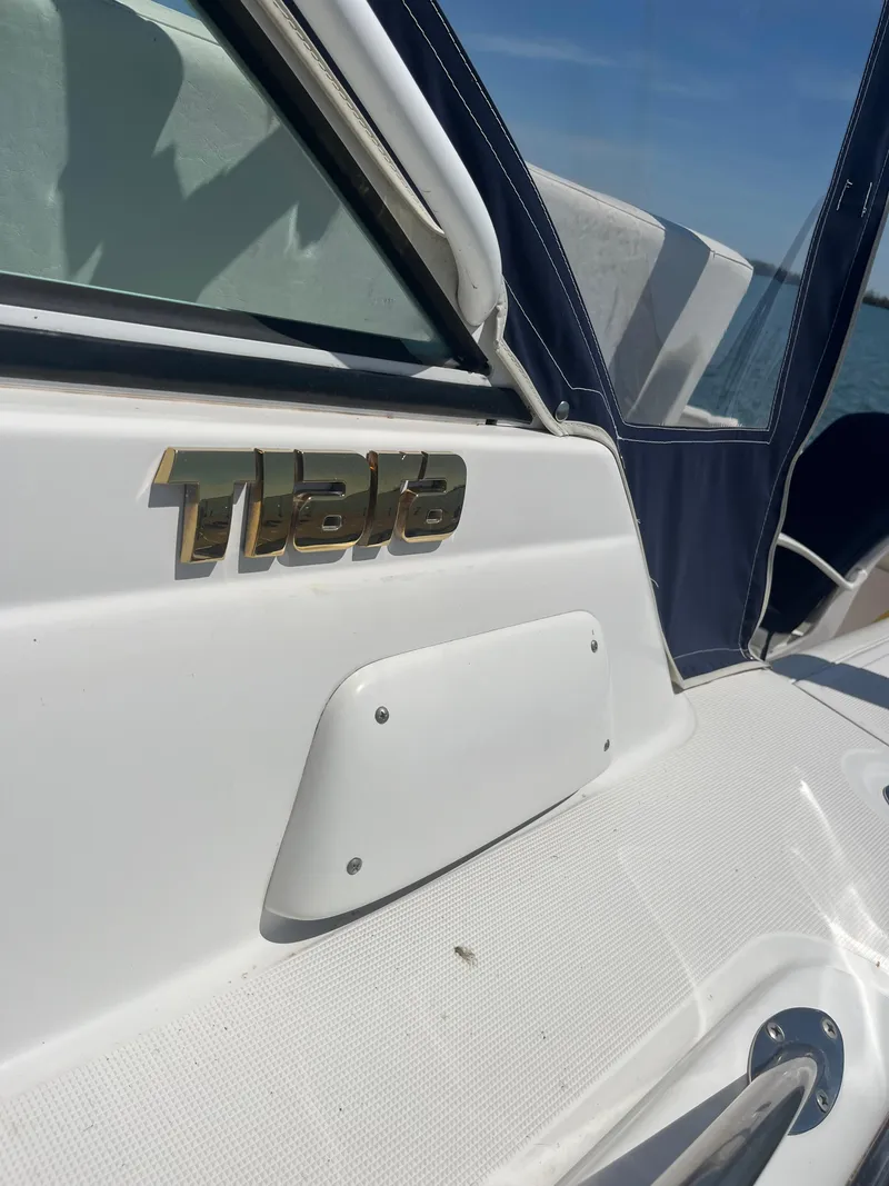 Slide: The Image of 2007 Tiara Yachts 2900 Coronet boat detail with logo and blue canopy. - 6