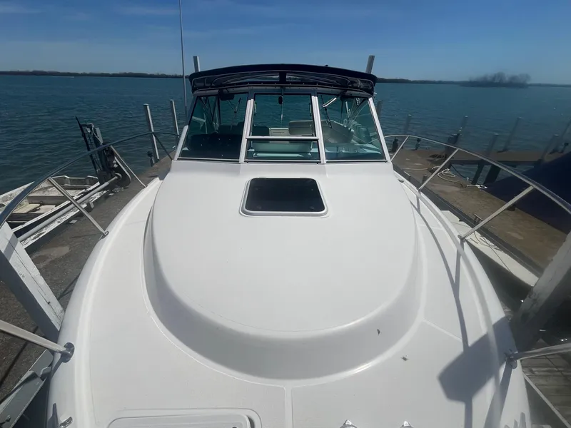 Slide: The Image of 2007 Tiara Yachts 2900 Coronet docked, showcasing sleek design and spacious deck. - 7