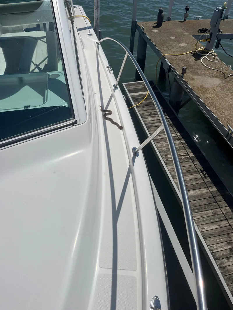 Slide: The Image of 2007 Tiara Yachts 2900 Coronet docked, showcasing sleek white deck and stainless steel railing. - 8