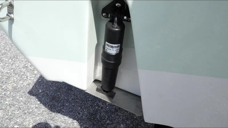 Slide: The Image of 2025 Tidewater 220 LXF boat trim tab actuator on a sunny day. - 12