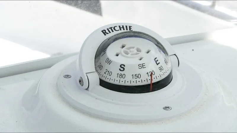 Slide: The Image of Compass on 2025 Tidewater 220 LXF boat dashboard, showing southeast direction. - 16