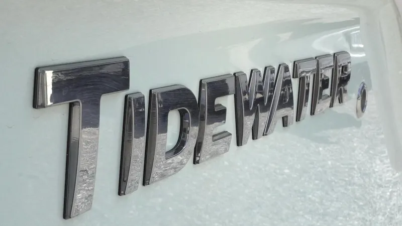 Slide: The Image of Close-up of Tidewater 220 LXF 2025 model logo on boat exterior. - 22