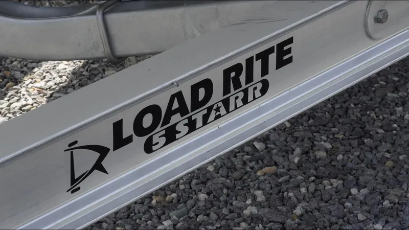 Slide: The Image of Trailer for 2025 Tidewater 220 LXF boat, featuring Load Rite 5 Starr branding. - 25