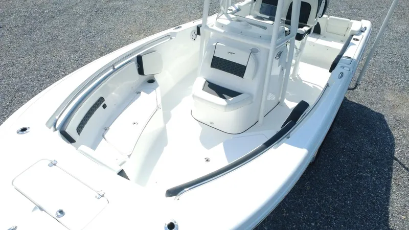 Slide: The Image of 2025 Tidewater 220 LXF boat, sleek white design, spacious deck, modern seating arrangement. - 26