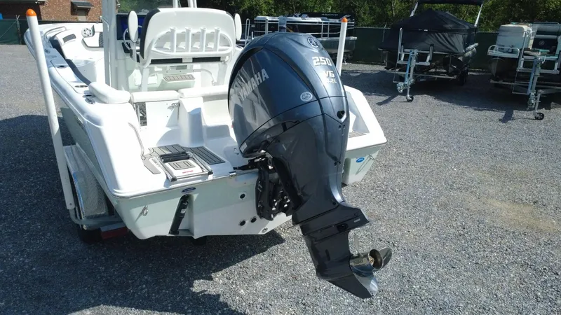 Slide: The Image of 2025 Tidewater 220 LXF boat with Yamaha outboard motor in a gravel lot. - 3