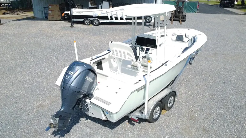 Slide: The Image of 2025 Tidewater 220 LXF boat on trailer with Yamaha outboard motor, parked outdoors. - 4