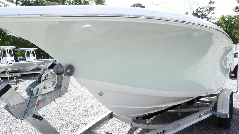 Slide: The Image of 2025 Tidewater 220 LXF boat on trailer, side view, in outdoor setting. - 8