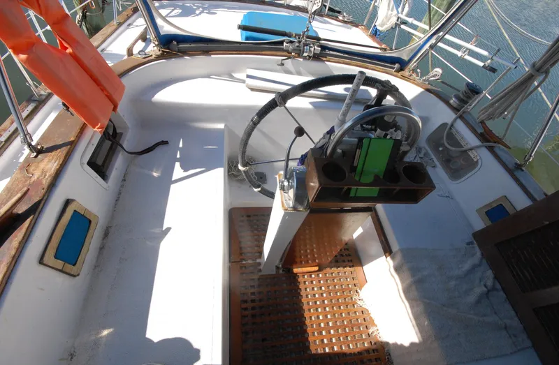 Slide: The Image of 1981 Endeavour 40 sailboat cockpit with steering wheel and nautical equipment. - 12