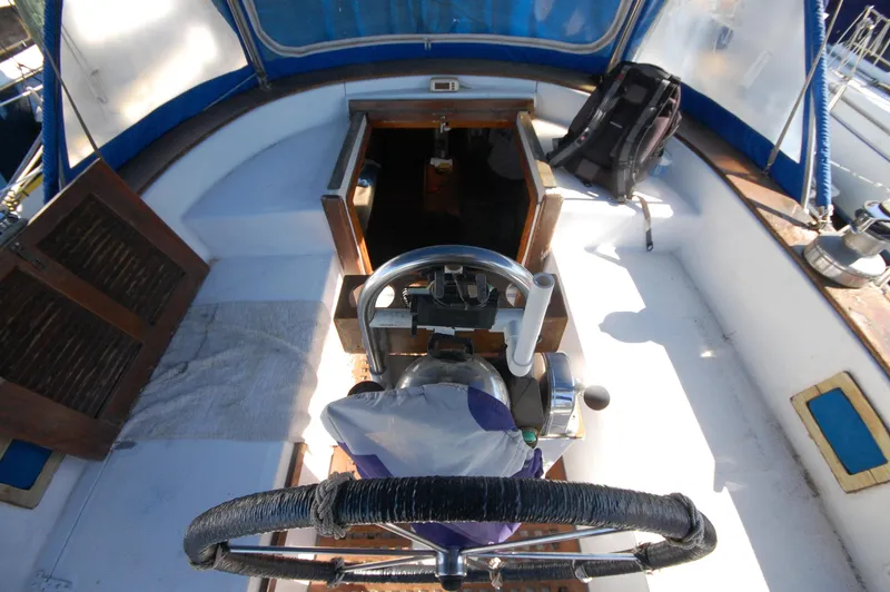Slide: The Image of Cockpit of 1981 Endeavour 40 sailboat with steering wheel and open hatch. - 13