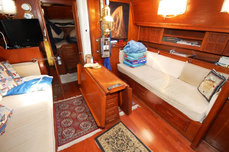 Slide: The Image of Interior of 1981 Endeavour 40 sailboat with cozy seating and wooden furnishings. - 15