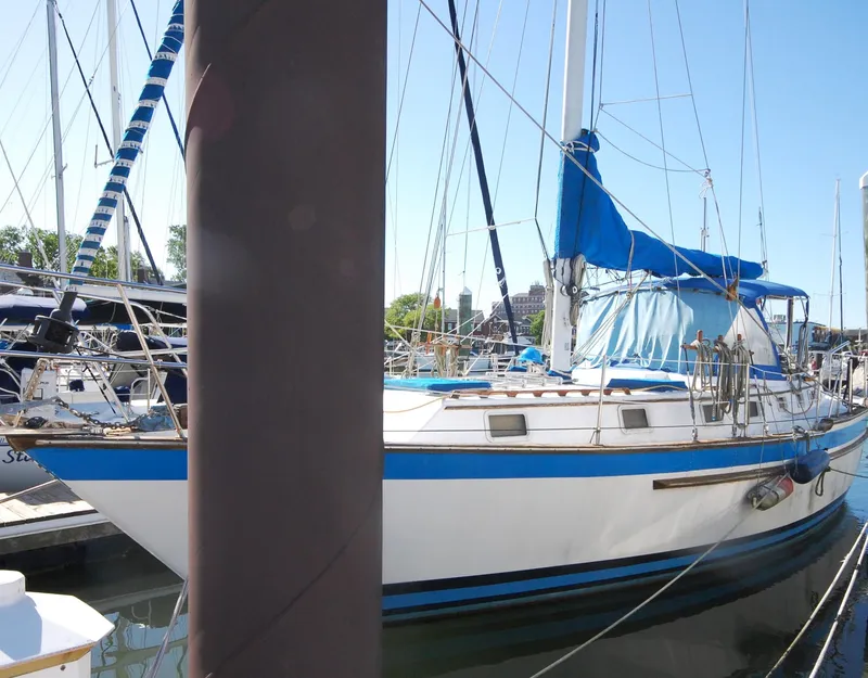 Slide: The Image of 1981 Endeavour 40 sailboat docked with blue and white accents. - 2