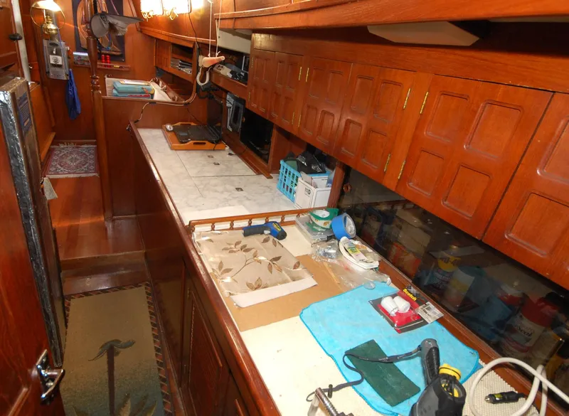 Slide: The Image of 1981 Endeavour 40 yacht interior with wooden cabinetry and workbench. - 21
