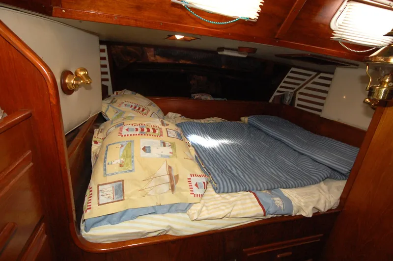 Slide: The Image of Cozy cabin interior of 1981 Endeavour 40 sailboat with nautical-themed bedding. - 22