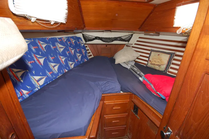 Slide: The Image of Cozy cabin interior of 1981 Endeavour 40 sailboat with nautical-themed bedding. - 25