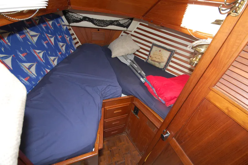 Slide: The Image of Cozy cabin interior of 1981 Endeavour 40 sailboat with nautical-themed bedding. - 26