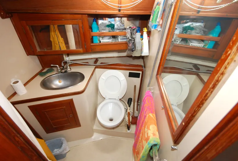 Slide: The Image of Compact bathroom in 1981 Endeavour 40 yacht with sink, toilet, and storage. - 27