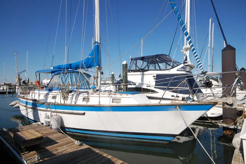 Slide: The Image of 1981 Endeavour 40 sailboat docked at a marina under clear blue skies. - 3