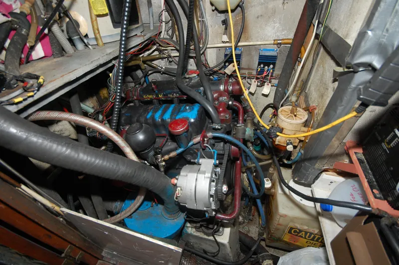 Slide: The Image of Engine room of a 1981 Endeavour 40 sailboat, showcasing complex wiring and components. - 33