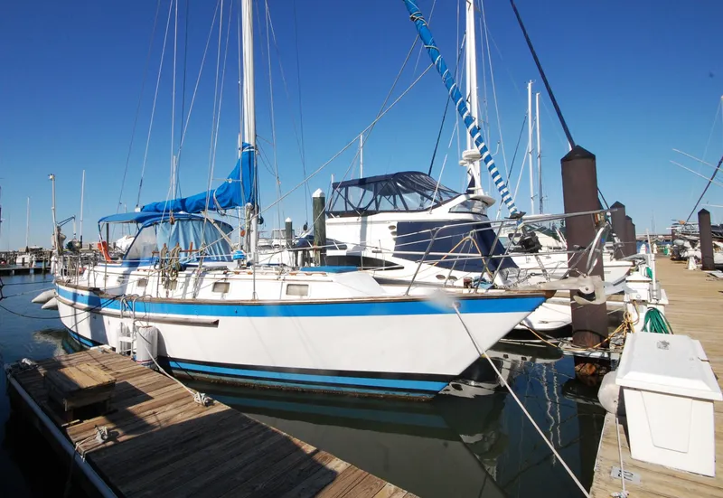Slide: The Image of 1981 Endeavour 40 sailboat docked at marina under clear blue sky. - 4