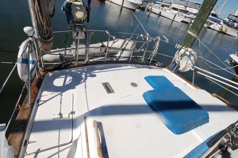 Slide: The Image of 1981 Endeavour 40 sailboat deck with marina view, featuring blue accents and railing. - 5