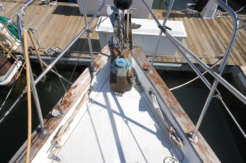 Slide: The Image of Bow of 1981 Endeavour 40 sailboat docked at marina, showing deck and railing. - 9