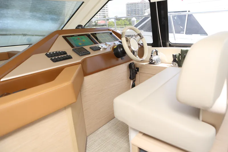 Slide: The Image of 2017 Beneteau Monte Carlo 4 helm with modern controls and beige seating. - 3