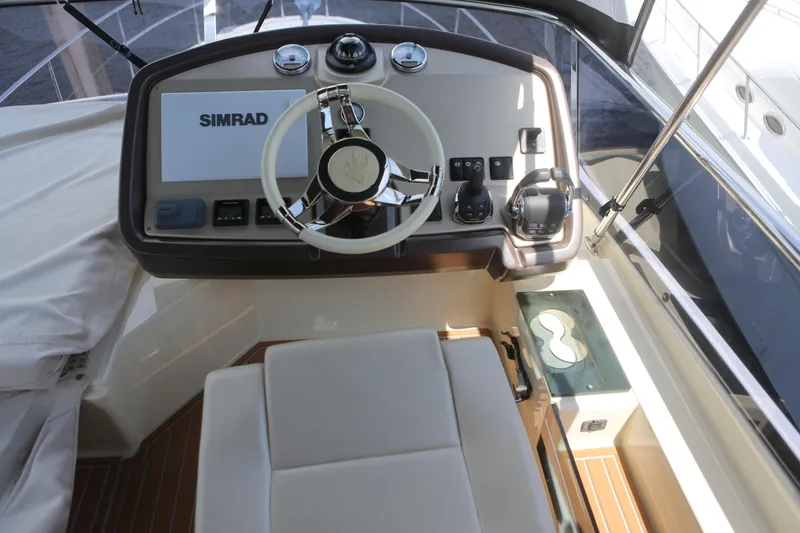 Slide: The Image of 2017 Beneteau Monte Carlo 4 helm with Simrad navigation system and modern controls. - 5