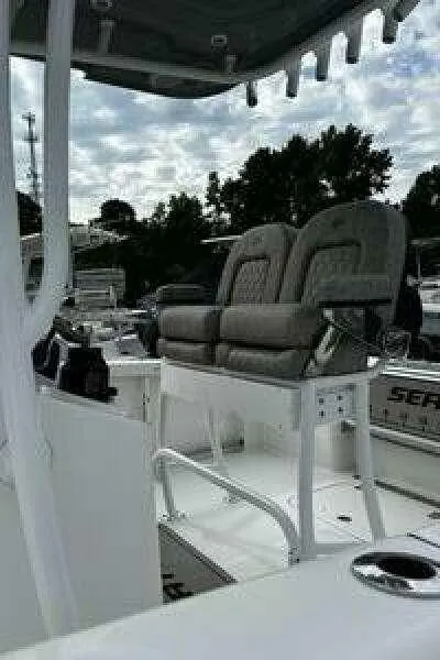 Slide: The Image of 2022 Sea Pro 219 Center Console boat with cushioned seating and canopy. - 12