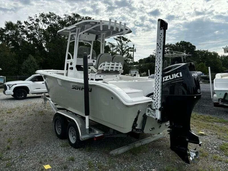 Slide: The Image of 2022 Sea Pro 219 Center Console boat on trailer with Suzuki outboard motor. - 2