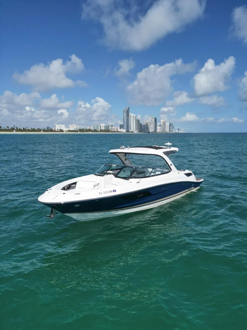 Slide: The Image of 2015 Sea Ray 350 SLX boat on ocean with city skyline in background. - 14