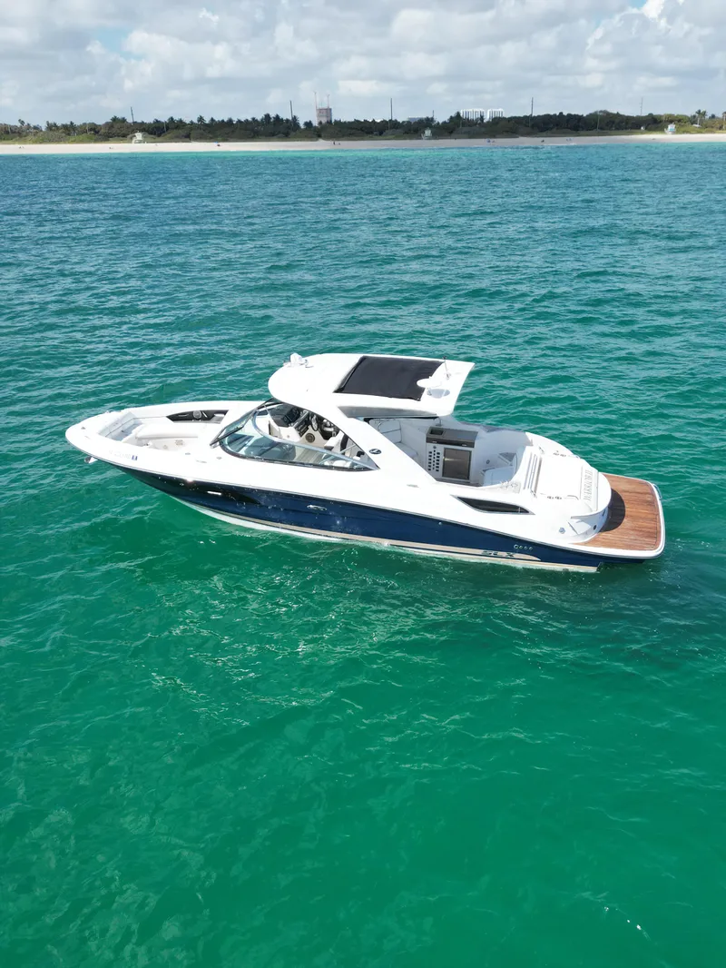 Slide: The Image of 2015 Sea Ray 350 SLX boat cruising on turquoise ocean waters. - 16