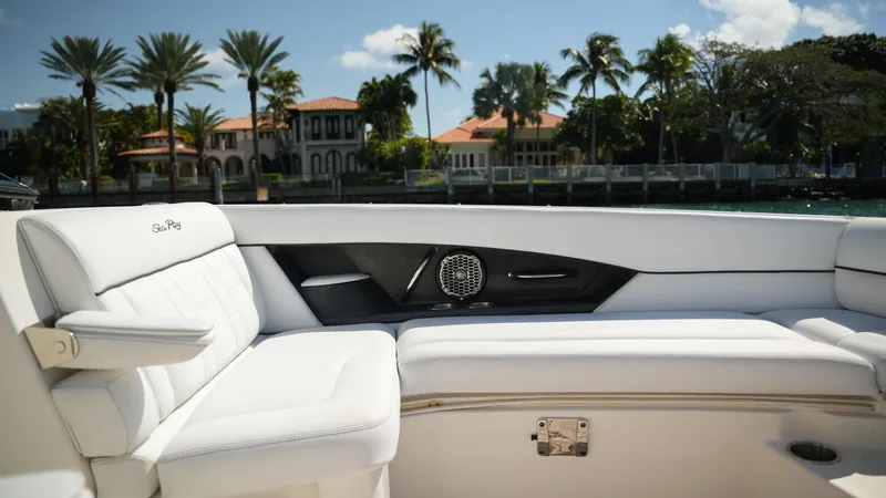 Slide: The Image of Luxurious 2015 Sea Ray 350 SLX boat interior with white seating, palm trees in background. - 27