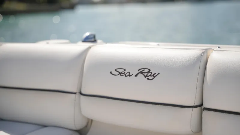 Slide: The Image of 2015 Sea Ray 350 SLX boat seat with logo, white upholstery, sunny day. - 29