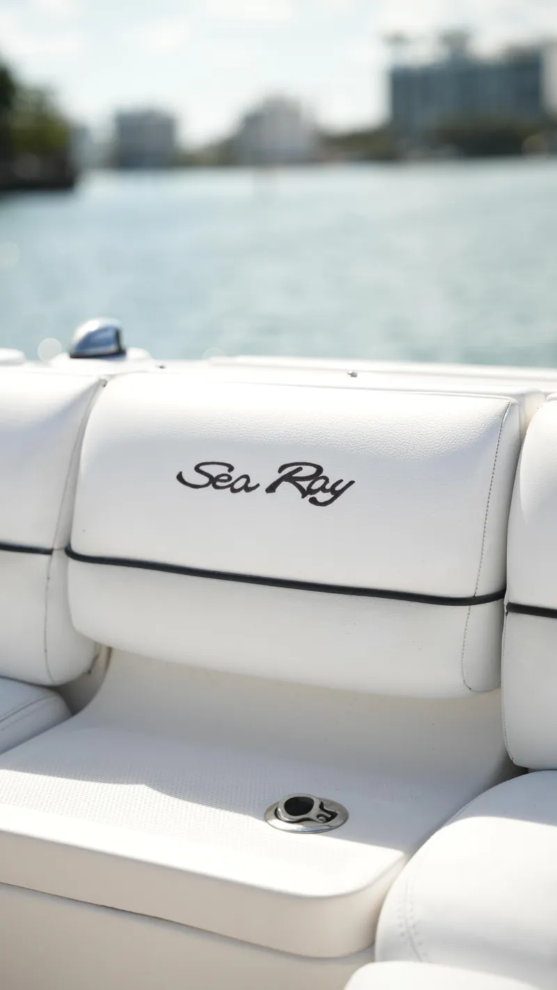 Slide: The Image of 2015 Sea Ray 350 SLX boat with white seating, logo visible, on a sunny day. - 30
