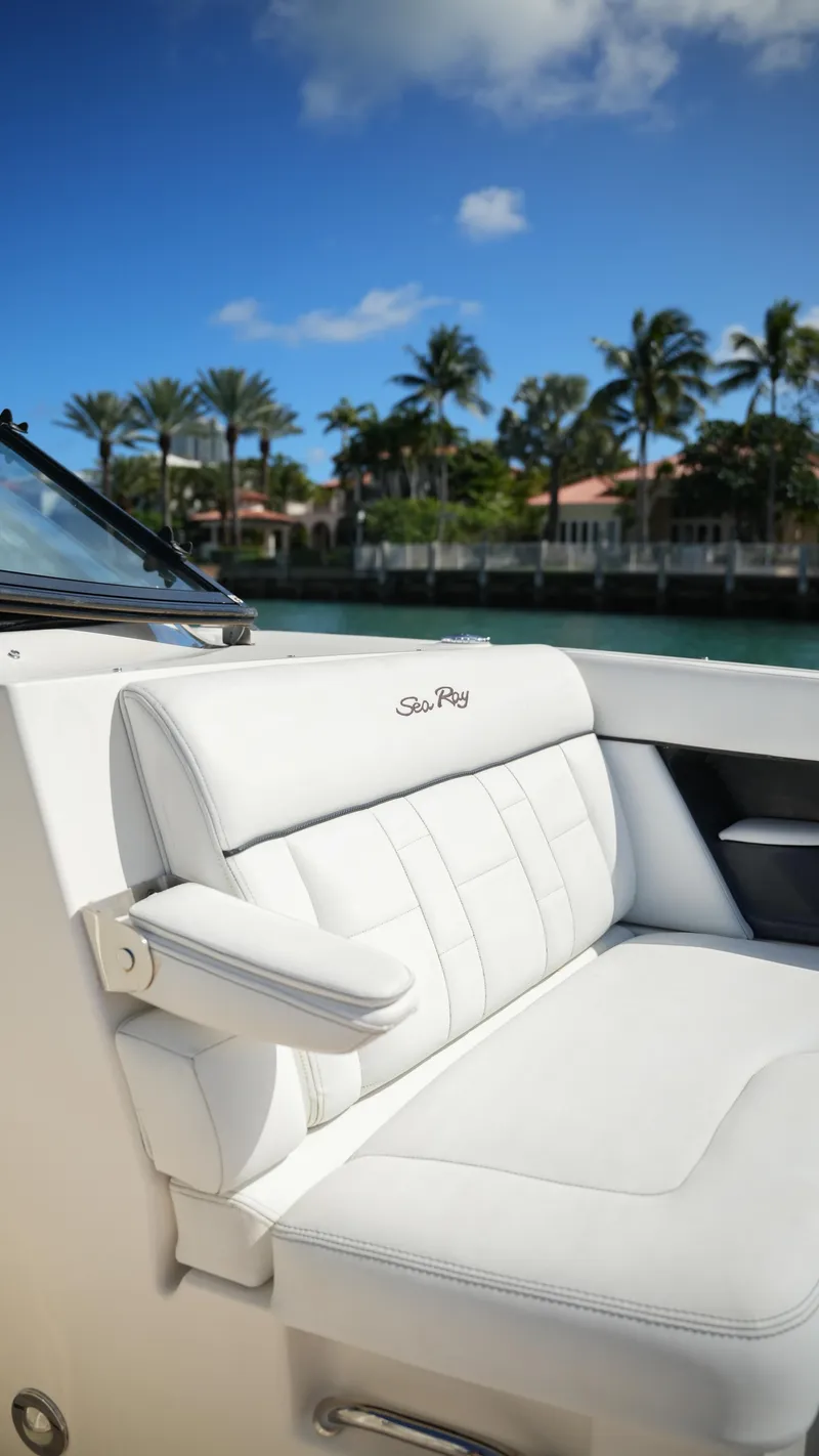 Slide: The Image of 2015 Sea Ray 350 SLX boat with white seating, palm trees, and blue sky background. - 31