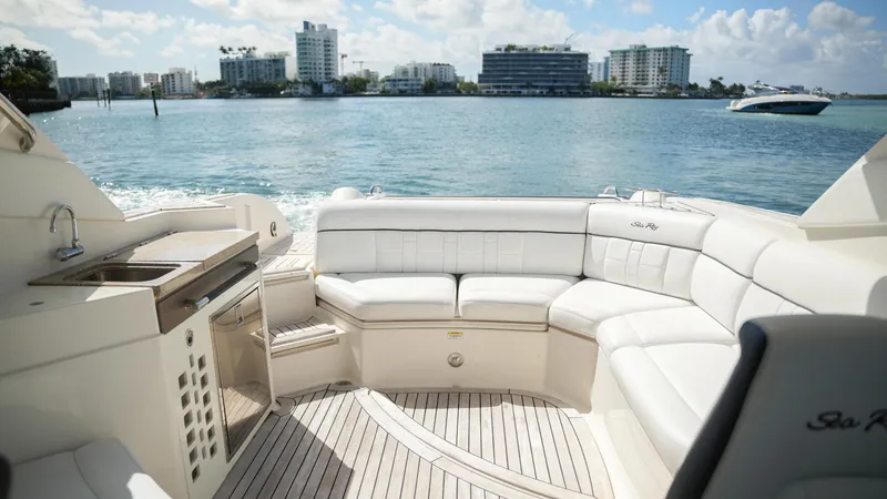 Slide: The Image of Luxurious 2015 Sea Ray 350 SLX yacht interior with white seating, ocean view, and city skyline. - 34