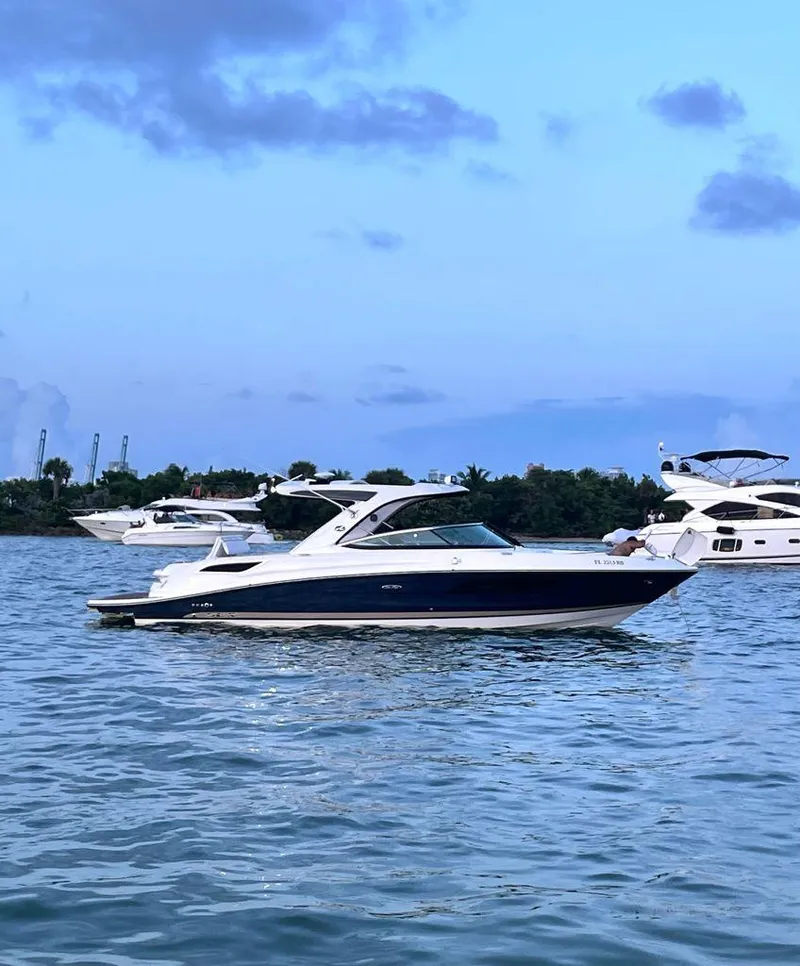 Slide: The Image of 2015 Sea Ray 350 SLX boat on calm water with blue sky background. - 4