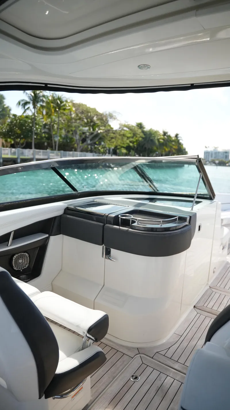 Slide: The Image of 2015 Sea Ray 350 SLX boat interior with sleek seating and modern dashboard. - 42