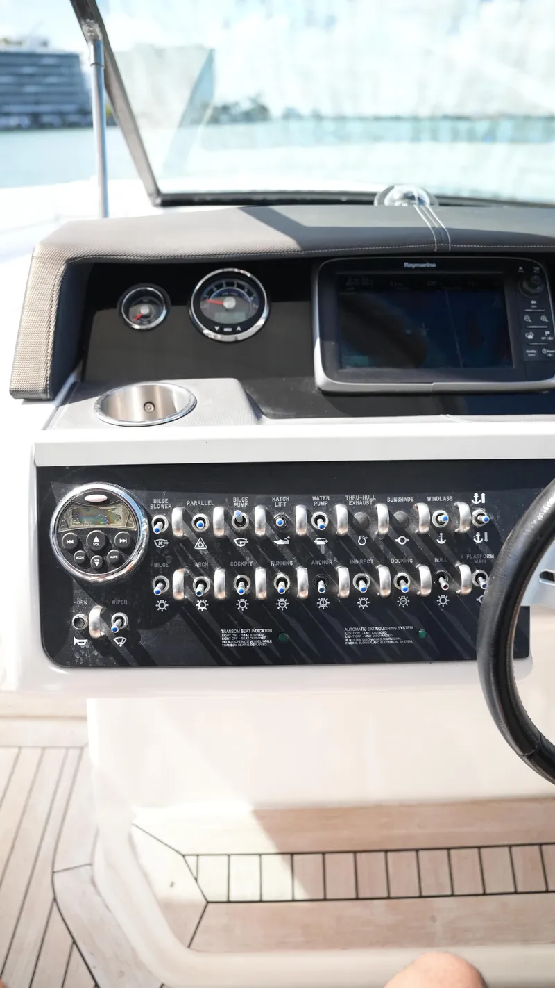 Slide: The Image of Control panel of a 2015 Sea Ray 350 SLX boat with gauges and switches. - 44