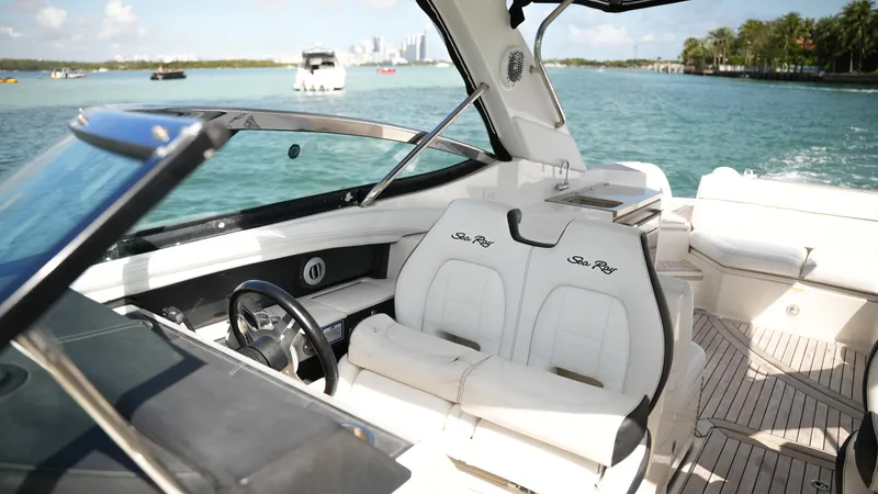 Slide: The Image of 2015 Sea Ray 350 SLX boat interior with luxurious seating on a sunny day. - 46
