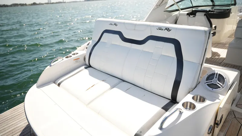 Slide: The Image of 2015 Sea Ray 350 SLX boat with luxurious seating and cup holders on a sunny day. - 49
