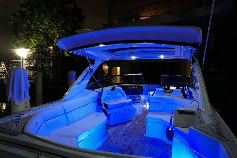 Slide: The Image of 2015 Sea Ray 350 SLX boat with blue LED lighting, spacious seating, and modern design. - 7